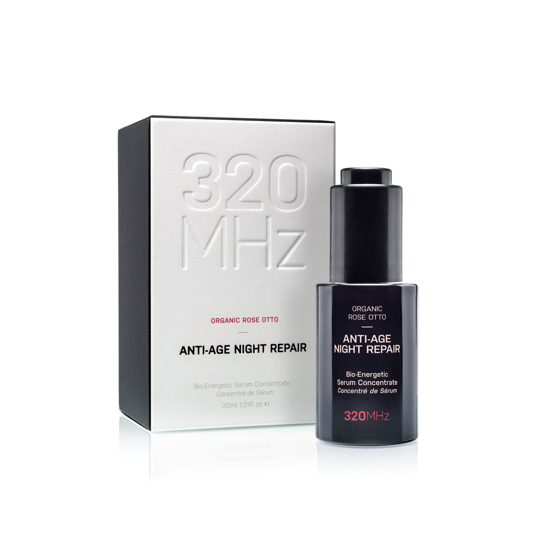 A bottle of Anti-Age Holistic Night Repair Face Serum with its packaging box, labeled 320 MHz brand, Organic Rose Otto.