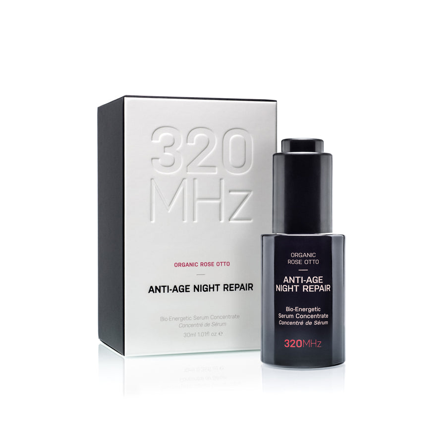 A bottle of Anti-Age Holistic Night Repair Face Serum with its packaging box, labeled 320 MHz brand, Organic Rose Otto.
