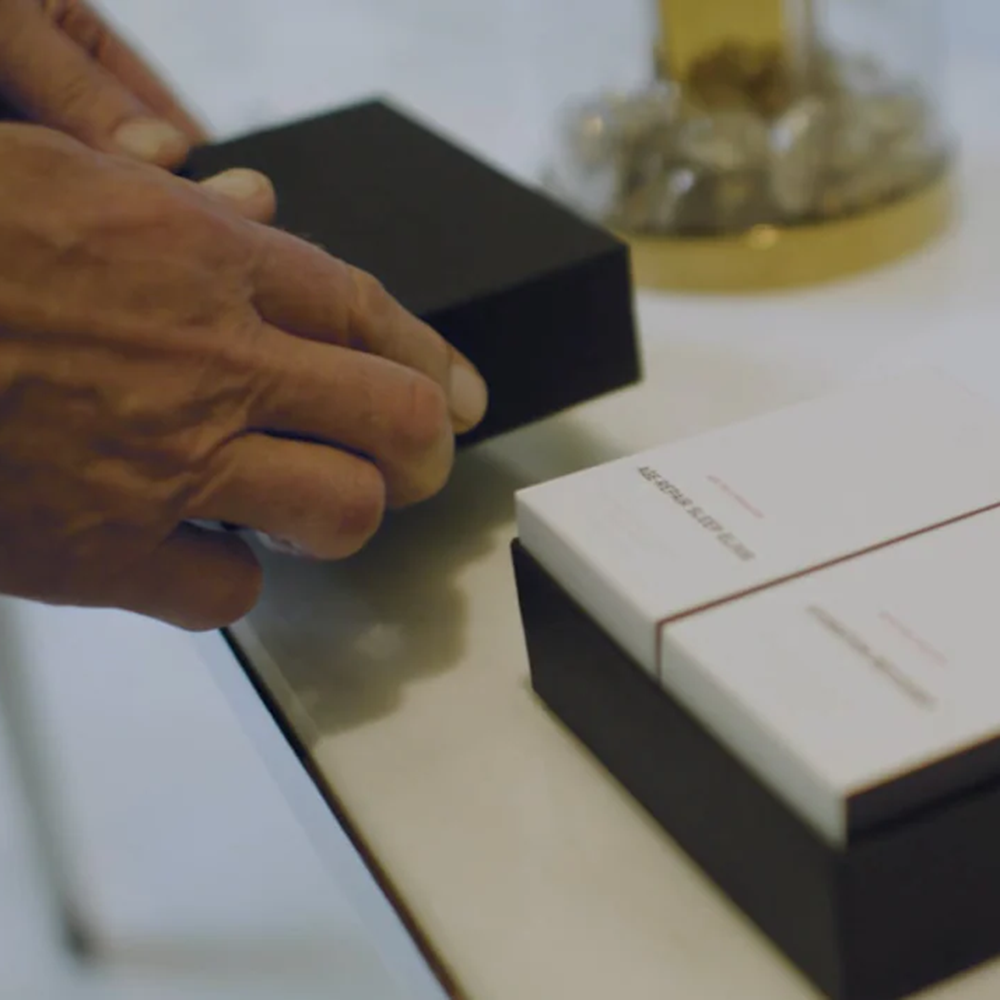hands unpacking gift set box of products